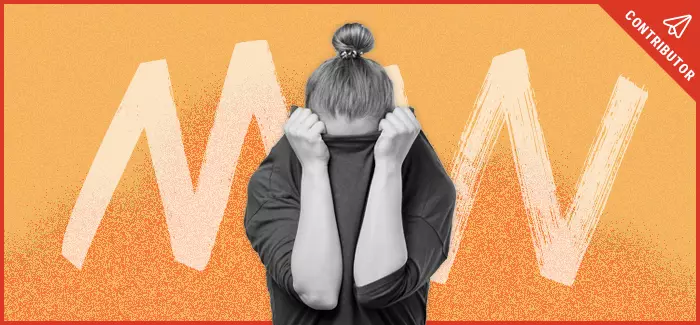 Woman hiding her face into her shirt after facing disability stigma.