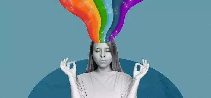 Peaceful woman with a rainbow coming out of her head to signify divergent thinking