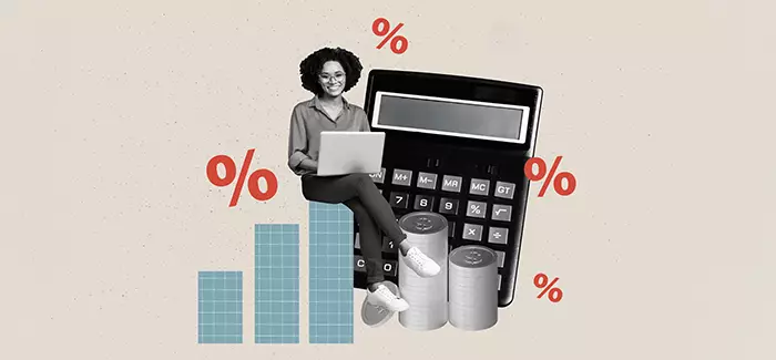 A female professional sitting next to a calculator to represent saving on a Ƶ degree