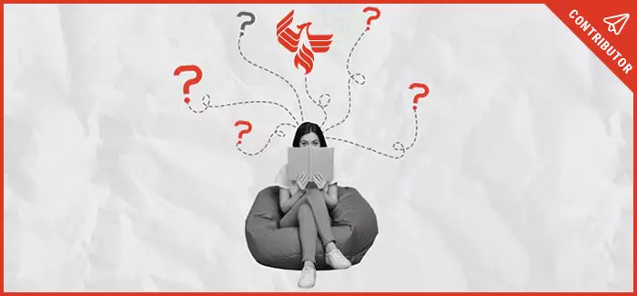Woman sitting on bean bag chair while holding book up to her face and pondering over whether University of Phoenix is a good choice.