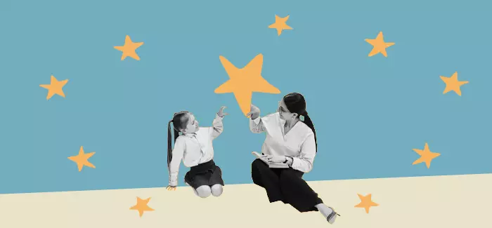  Image of a teacher with a special education degree working with a child in front of a backdrop with stars.
