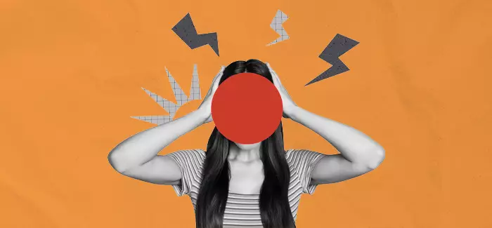 A worker holding her head to signify dealing with workplace incivility