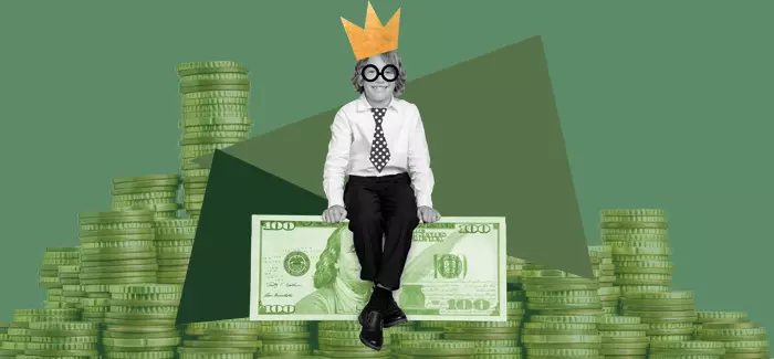 A kid sitting on top of money to signify financial literacy for kids