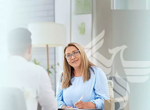 Two people in a professional conversation, representing an online bachelor’s in social work program.