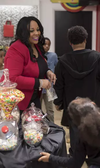 Felicia interacts with children in her candy store