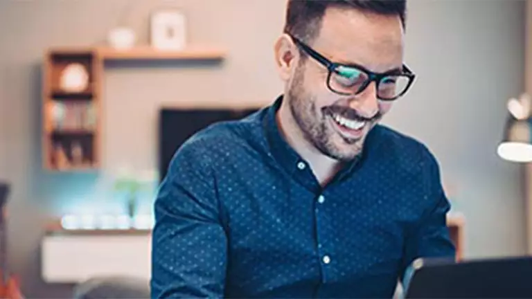 Woman at computer excited about her savings possibilities.