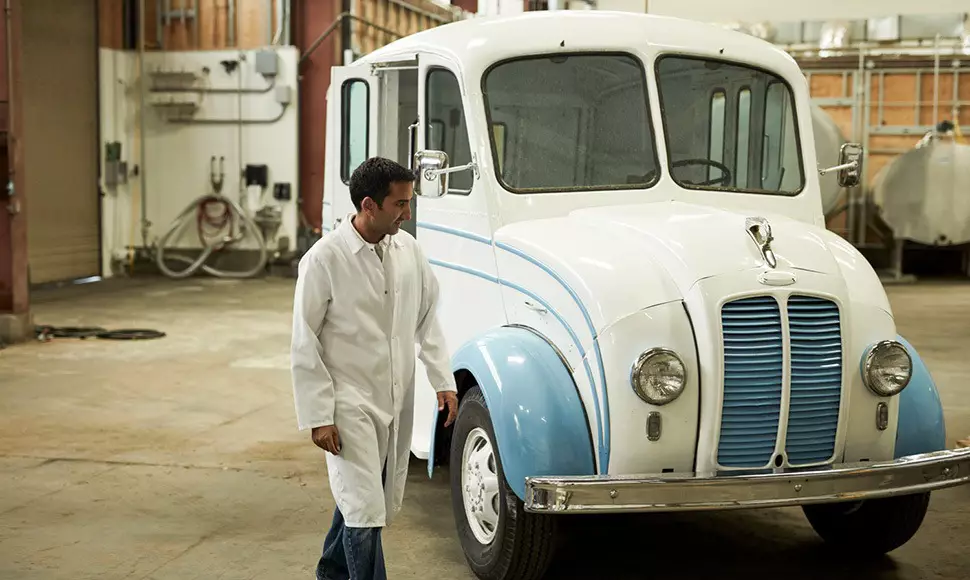 Nindi walks near a delivery truck in his warehouse