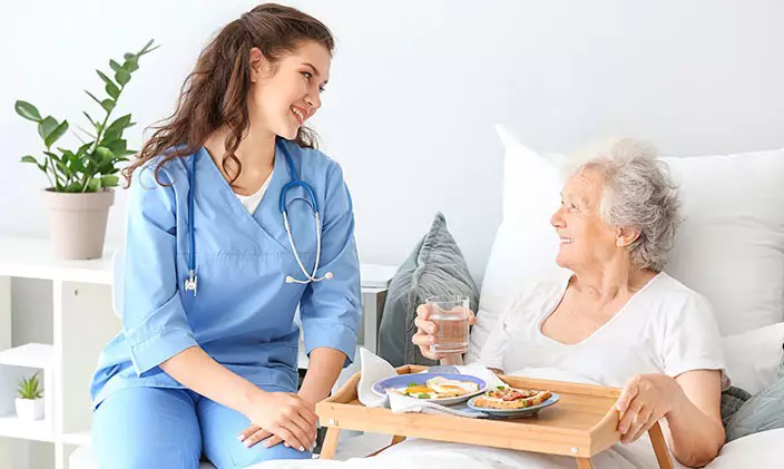 A certified nursing assistant helps patients with things like eating and bathing