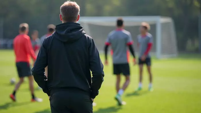 A coach looking on at soccer team