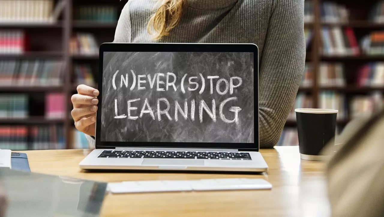 A laptop that reads "never stop learning"