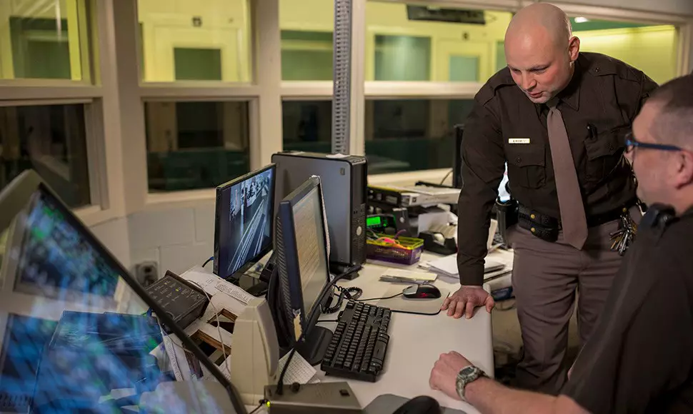 Criminal justice professionals looking over data on computer
