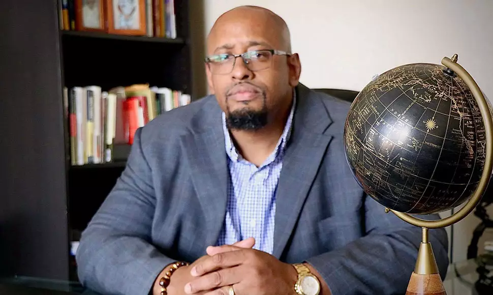 Dexter Peggins Jr. looks contemplative at his desk