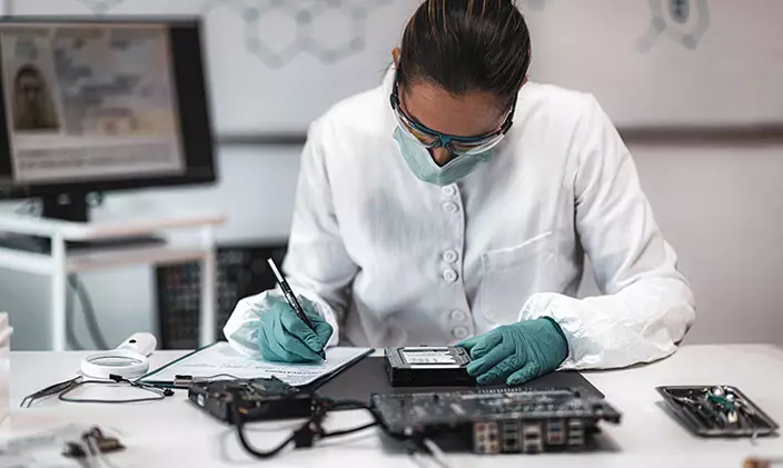 Female digital forensics professional working on a computer