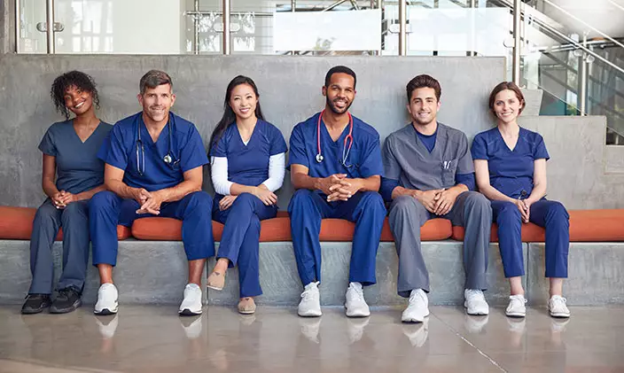 A group of nurses, representing the diversity in the field, poses for a photo