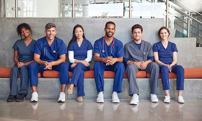 Group of male and female nurses sitting inside a hospital