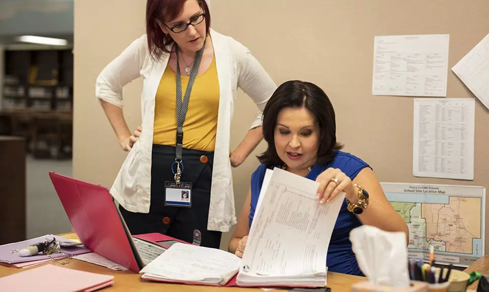 Educators collaborate in a school office setting