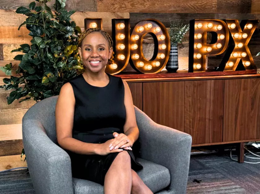 Degrees of Success host Freda Richards smiling while sitting in the studio.