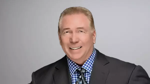 Edward Spear smiling for headshot in professional attire