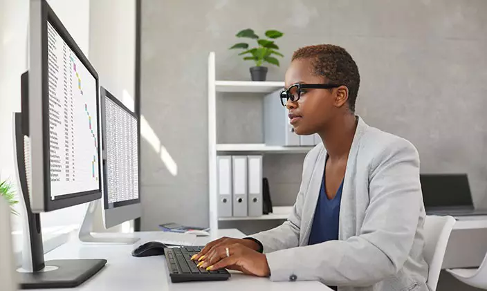 Female financial accountant analyzing data at a desk
