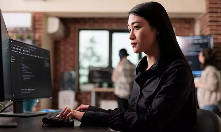Female information technology professional writing code
