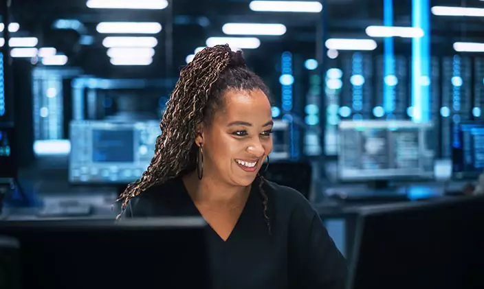 African American female IT professional smiling at work