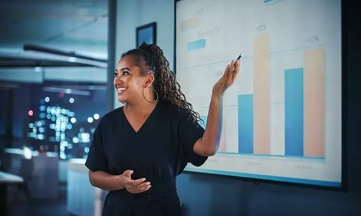 A marketing manager confidently giving a business presentation.