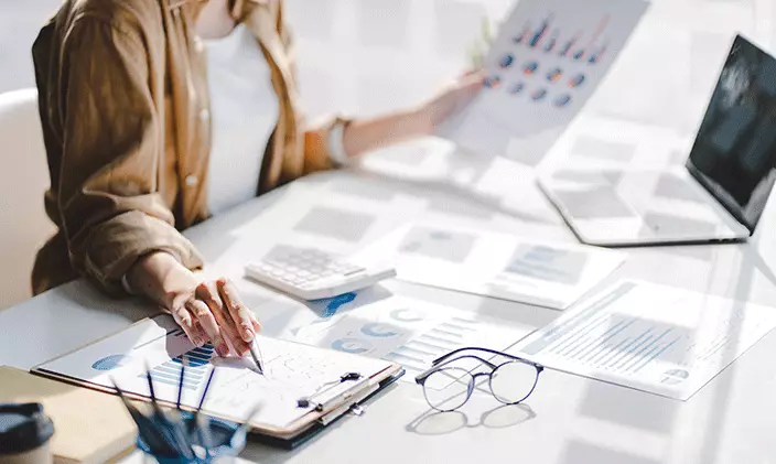 Employee reviewing financial documents on a desk