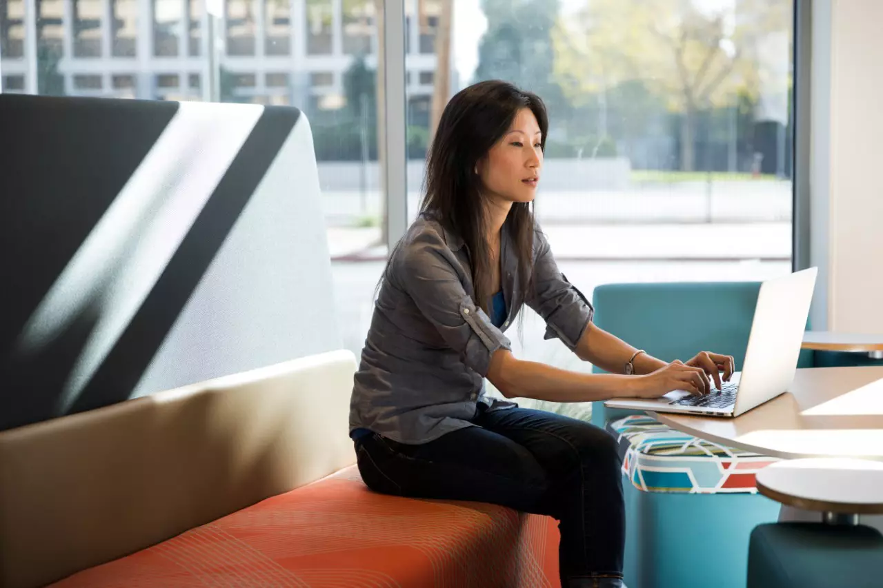 Employee working at table on a laptop