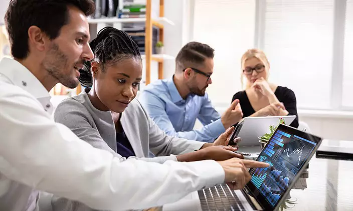 Group of business people looking at computers