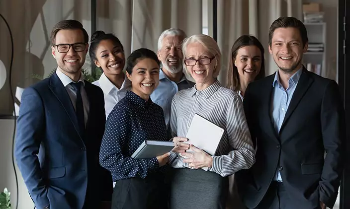 Group of friendly and diverse professionals smiling at the camera