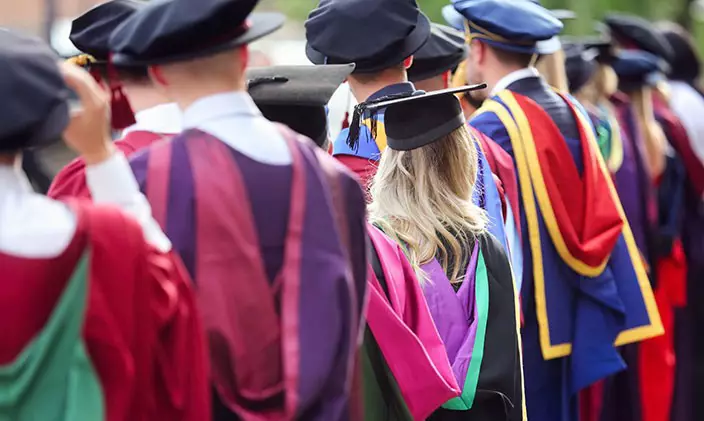 A group of doctorate graduates wearing full regalia.
