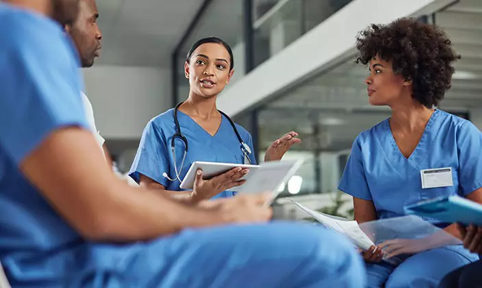 Female nurse working with colleagues in a hospital