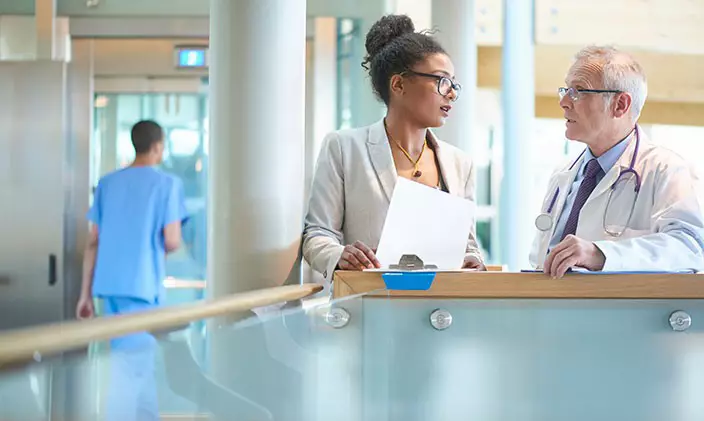 A doctor converses with a hospital administrator. Could this be your future? 