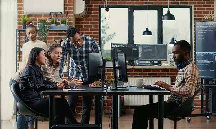 IT professionals collaborate in an open loft environment