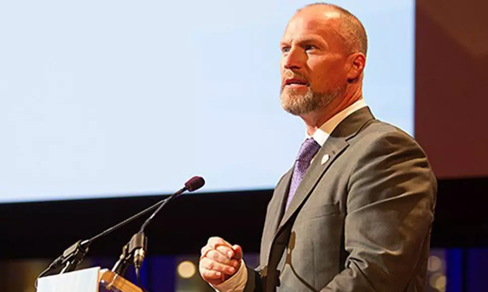 Alumnus Jake Clark gives a speech about Save A Warrior