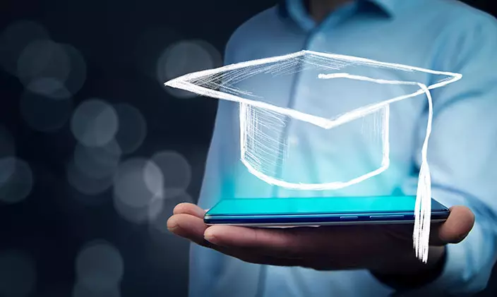 Animated graduation cap floating above smart phone in someone's palm
