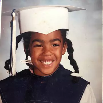 Photo of a young Mautra Jones in a graduation cap