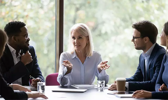 A middle manager leads a staff meeting