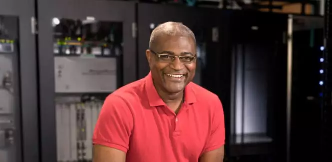 IT Professional starts job in a room with servers.