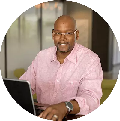 Man works at his laptop at his job as a network security analyst.