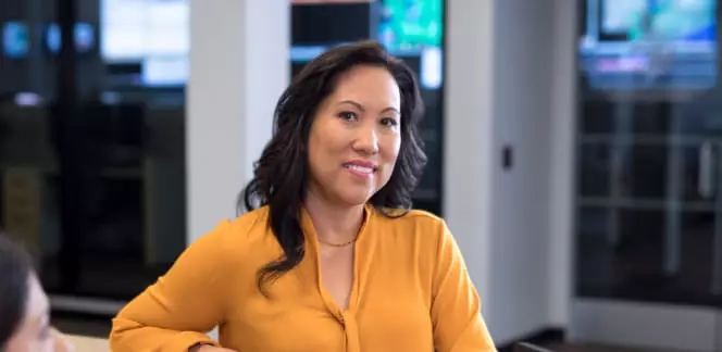 IT professional meets with others on her team.