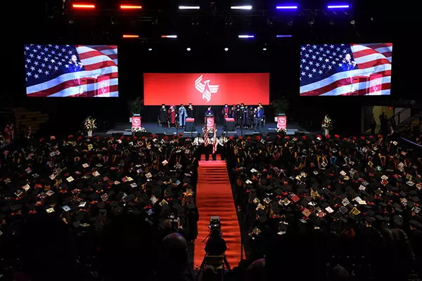 Graduates fill the Addition Financial Arena for ۴ý's commencement ceremony.