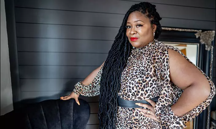 Paula Johnson-Hutchinson strikes a powerful pose in a leopard-print dress