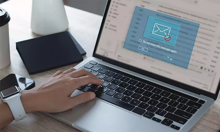 A person receiving a suspicious email on their laptop to signify dealing with phishing and spear phishing