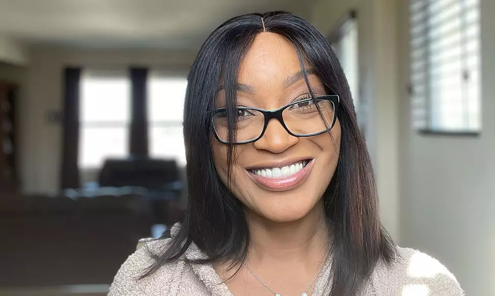 Shammai Terry wearing glasses and smiling