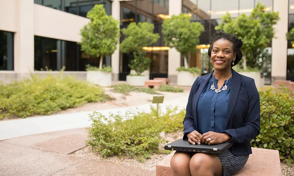 A social worker enjoys a free moment outside a courthouse