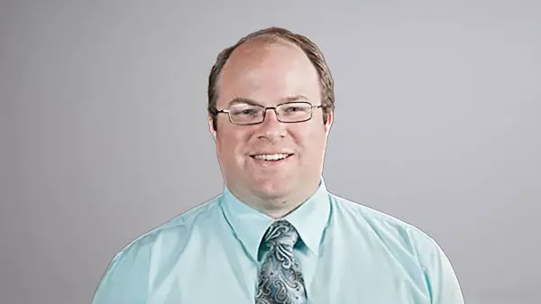 Troy L. Adams smiling for headshot in professional attire