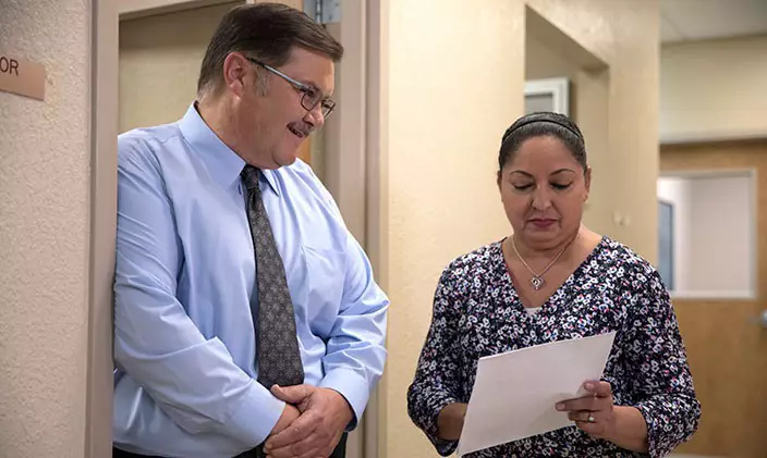 Two criminal justice professionals discussing the difference between criminal justice and criminology