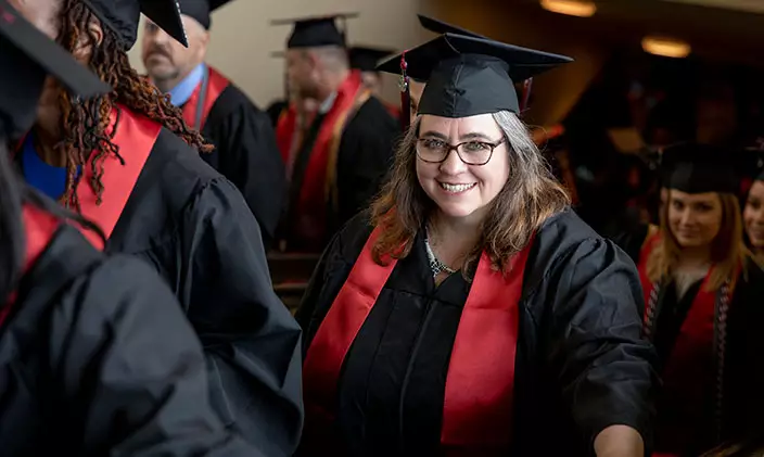 Smiling women in graduation crowd