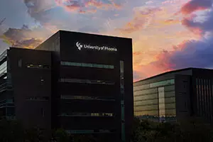 Link to an image of the ʿ¼ building silhouetted against a pink and purple sky